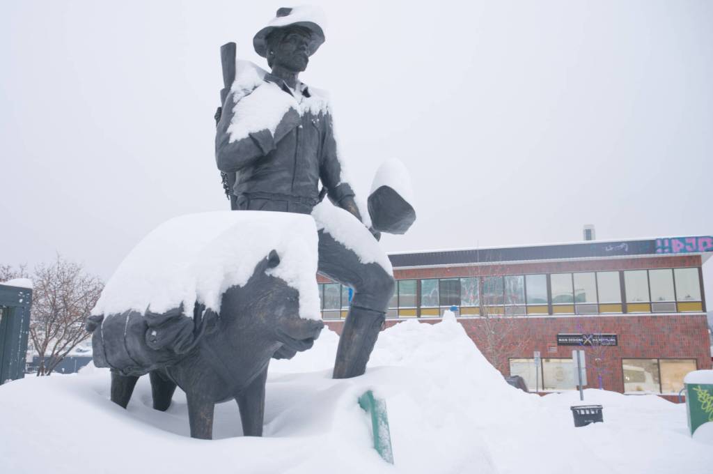 Snow blankets the prospector statue in downtown Whitehorse on Dec. 29, 2025. (Jim Elliot/Yukon News)