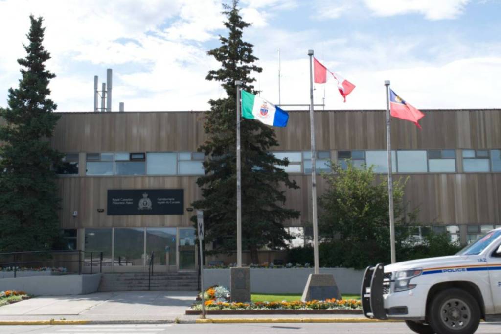 A police cruiser passes by the RCMP station in Whitehorse on Aug. 22, 2022. (Dana Hatherly/Yukon News)